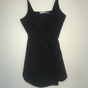 Black romper with asymmetric front flap and deep v